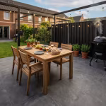Tuinterras met GeoCeramica Uros Plus Tar tegels, houten eettafel, pergola en barbecue
