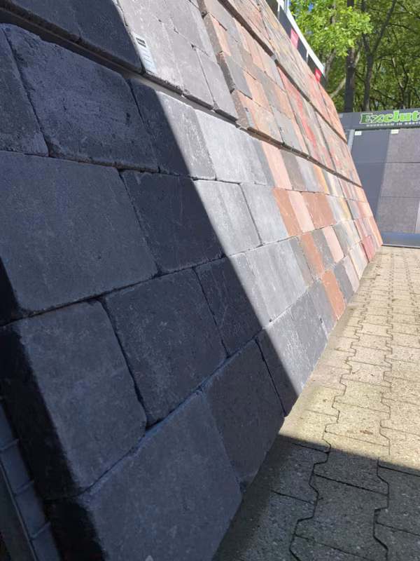 Showroomwand met Tambour Antraciet en rode stenen in zon en schaduw, buiten