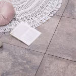 GeoCorso Ancona tegels op terras met kleed, kussen, opengeslagen boek en kopje koffie