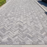 Oprit met WG Stone Trommelsteen 20x5x7 Grijs in visgraatverband en rechte afboording